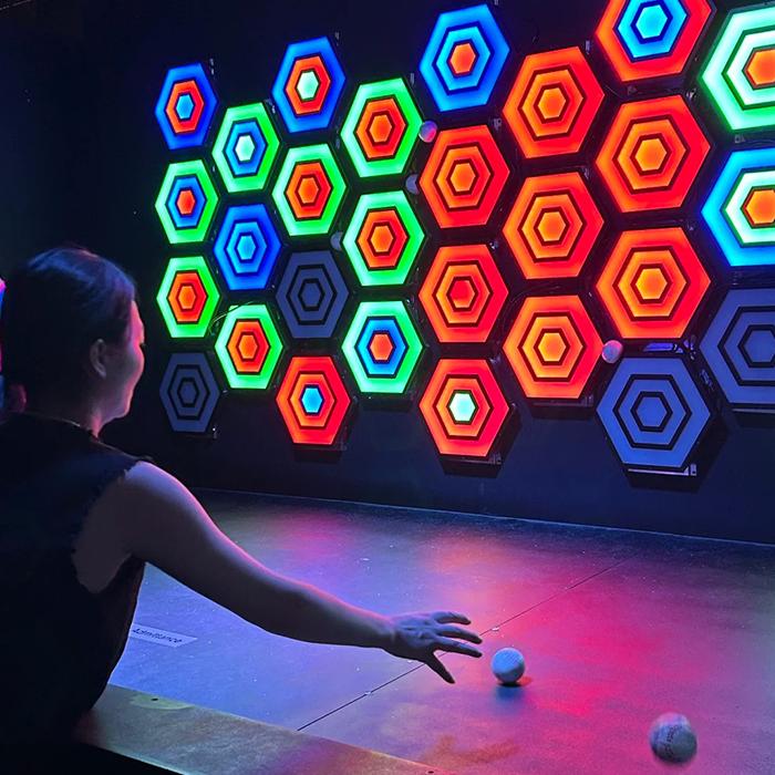 Hexagonal coloured targets on an interactive throwing wall